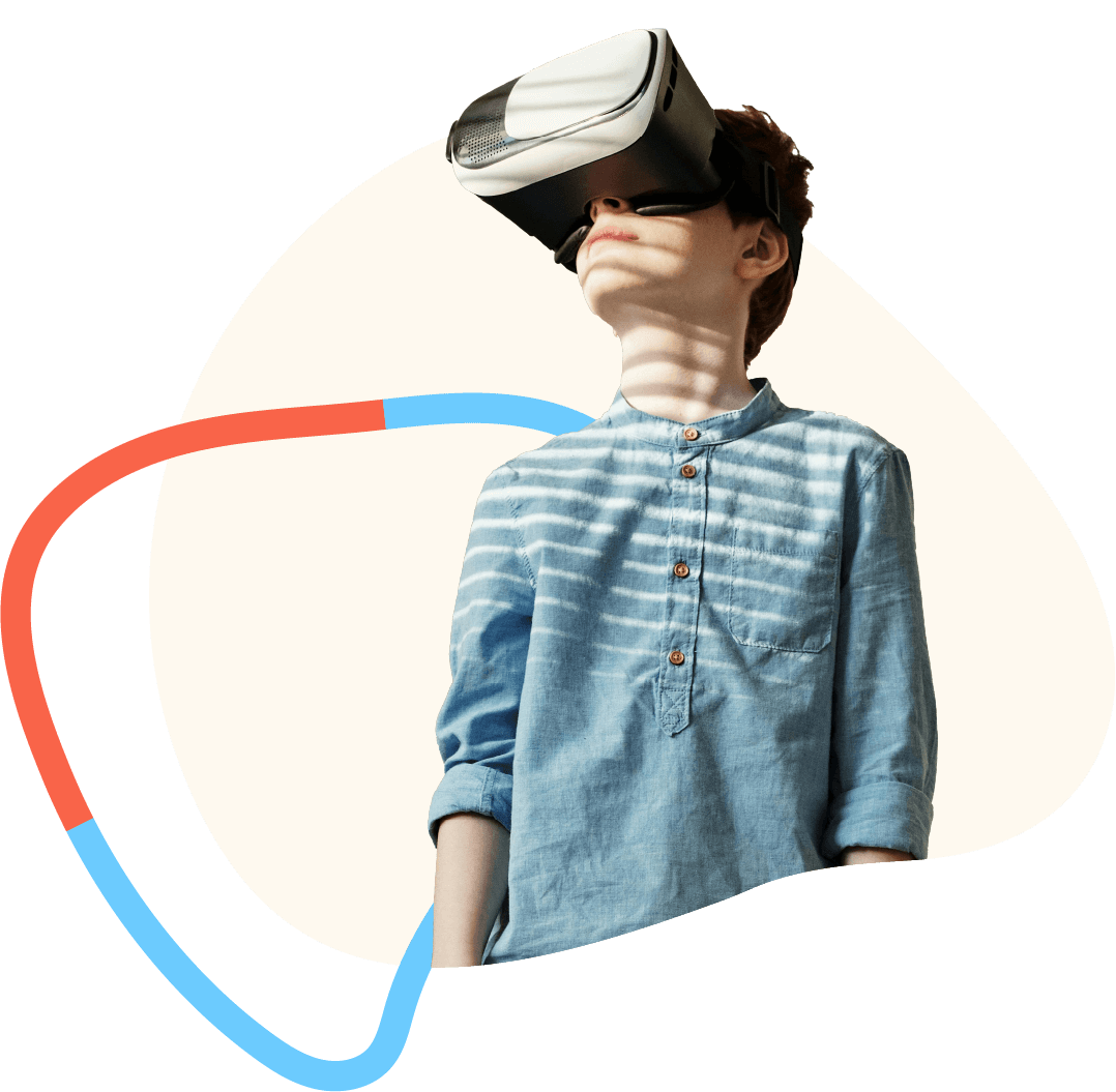 Young boy in blue denim shirt wearing a virtual reality headset